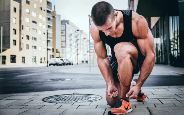 Photo by Alexander Red man tying his shoes