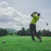 Photo by Courtney Cook photo of man swinging golf driver